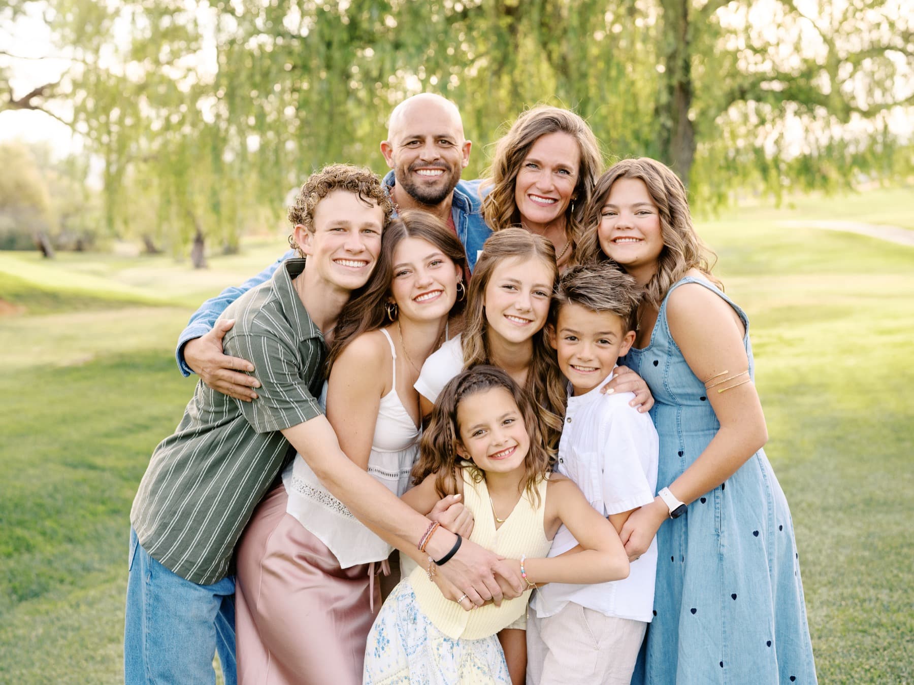 Natalie with her family in soft outdoor light